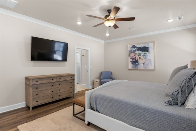 bedroom with visible vents, ornamental molding, baseboards, and wood finished floors