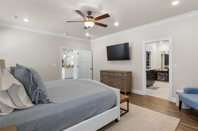 bedroom featuring recessed lighting, crown molding, and wood finished floors