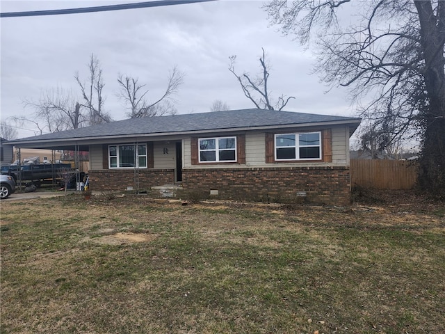 view of front of house featuring an attached carport, a front yard, fence, crawl space, and brick siding