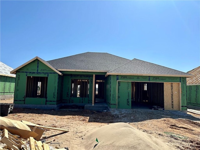 unfinished property featuring roof with shingles