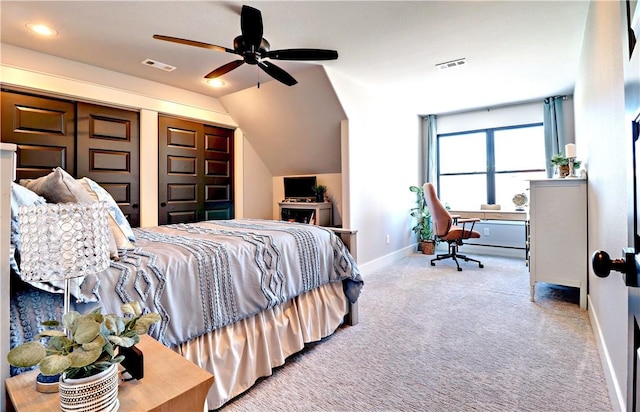 bedroom with visible vents, baseboards, carpet, and lofted ceiling