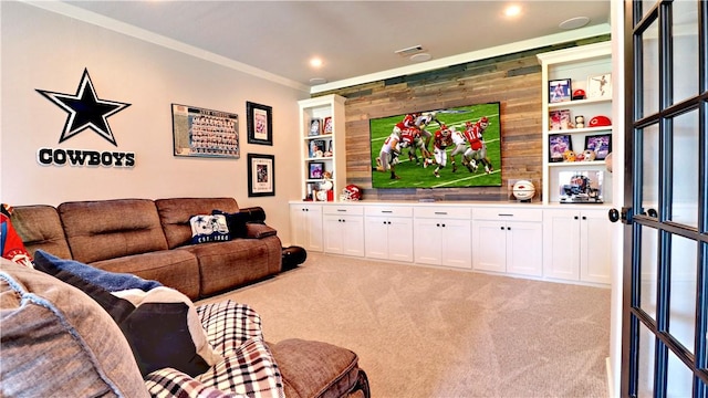 cinema room with recessed lighting, light colored carpet, wood walls, and ornamental molding