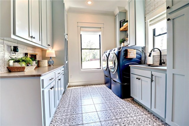 clothes washing area featuring light tile patterned floors, washing machine and clothes dryer, cabinet space, recessed lighting, and a sink