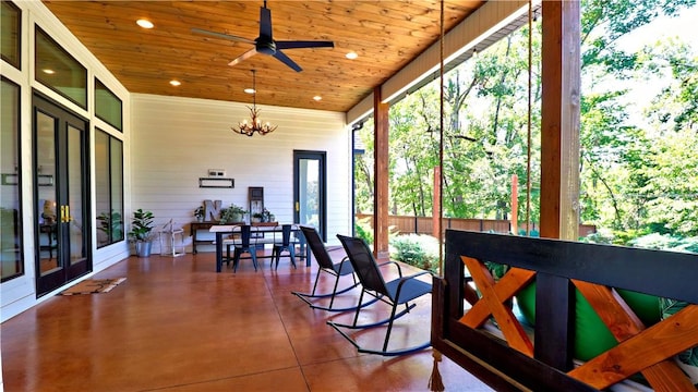 sunroom / solarium with wood ceiling and ceiling fan with notable chandelier