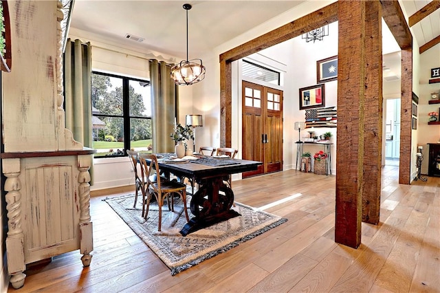 dining space with visible vents, baseboards, and hardwood / wood-style flooring