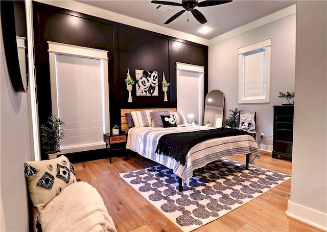 bedroom with ceiling fan and light wood-style flooring