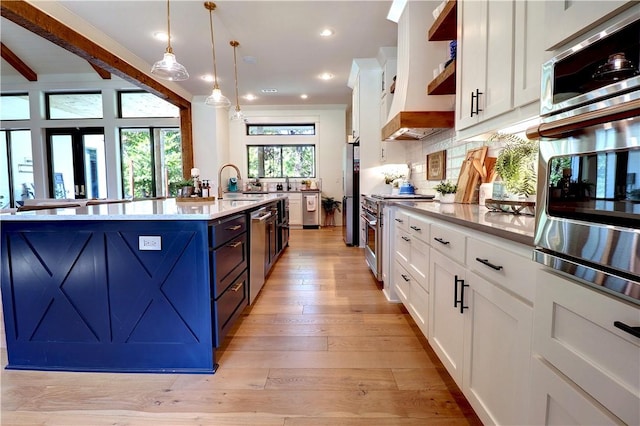 kitchen with open shelves, tasteful backsplash, light wood-style floors, appliances with stainless steel finishes, and white cabinets