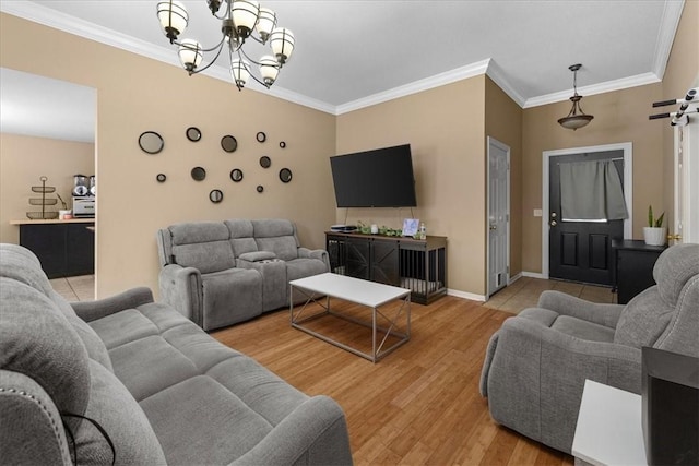 living room featuring crown molding, baseboards, and light wood-type flooring