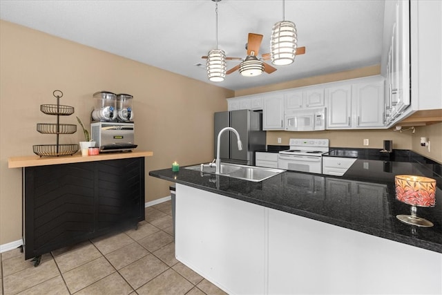 kitchen featuring a sink, white cabinetry, white appliances, a peninsula, and hanging light fixtures