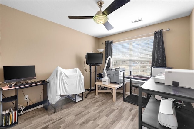 home office with baseboards, wood finished floors, visible vents, and ceiling fan