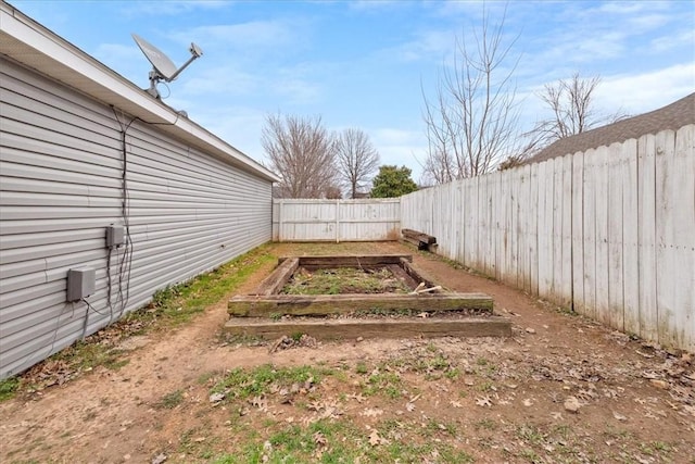 view of yard featuring a vegetable garden and a fenced backyard