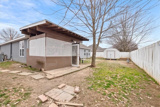 view of yard with a fenced backyard, a storage shed, and an outdoor structure