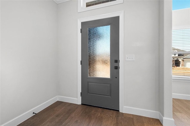 doorway featuring visible vents, baseboards, and dark wood-style flooring