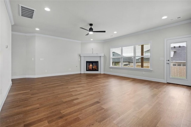 1804 Charles St, Pea Ridge, AR 72751 - unfurnished living room with a ceiling fan, wood finished floors, crown molding, recessed lighting, and a glass covered fireplace