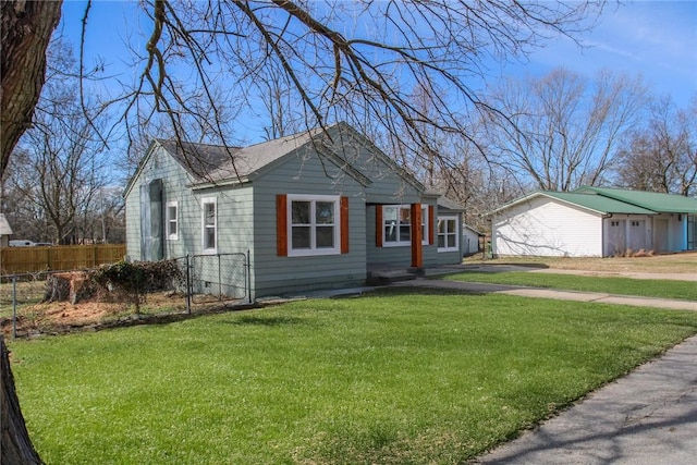 view of front of home featuring crawl space, a garage, a front yard, and fence