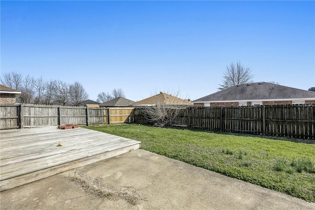 view of yard featuring a deck and a fenced backyard