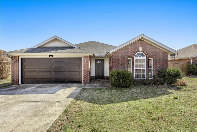 single story home with a front lawn, roof with shingles, concrete driveway, an attached garage, and brick siding