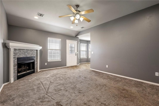 unfurnished living room featuring a fireplace, carpet, visible vents, and baseboards