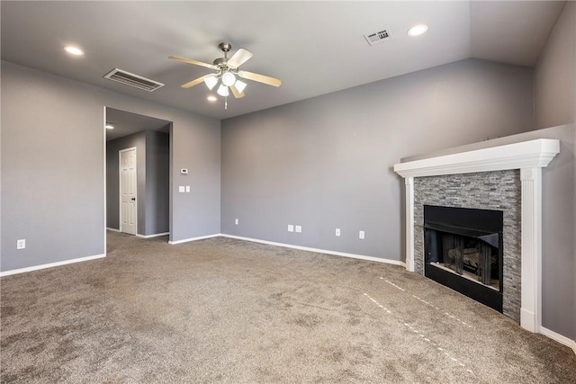 unfurnished living room with carpet flooring, a fireplace, visible vents, and ceiling fan