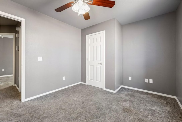 unfurnished bedroom featuring carpet flooring, a ceiling fan, and baseboards