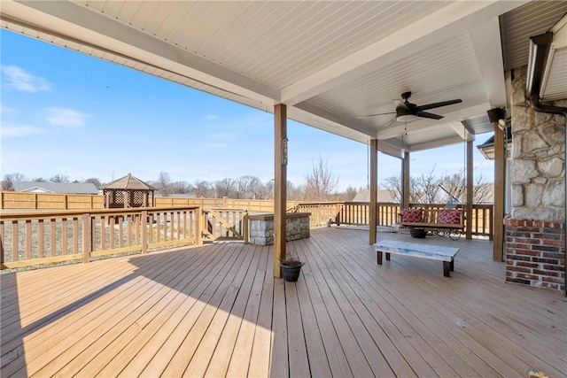 wooden deck featuring fence and ceiling fan