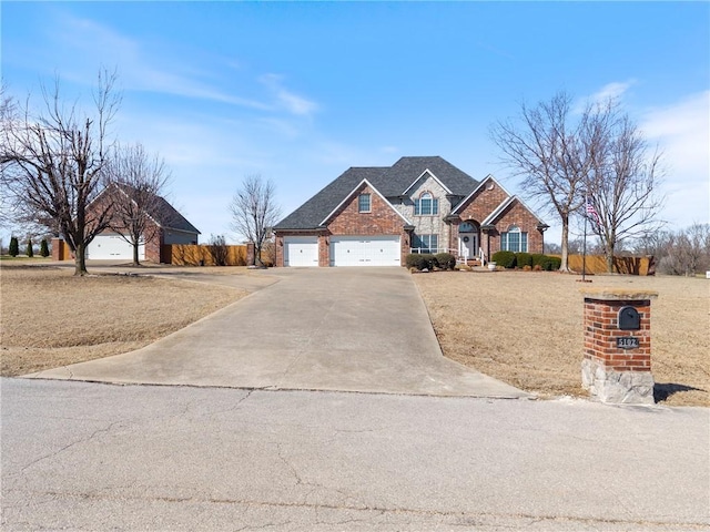 view of front of property with a garage, brick siding, and driveway