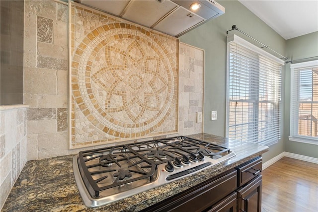 5102 Grove Dr, Rogers, AR 72758 - kitchen with stainless steel gas cooktop, wood finished floors, dark brown cabinetry, baseboards, and dark stone countertops