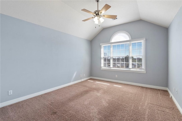 spare room with carpet flooring, ceiling fan, baseboards, and lofted ceiling