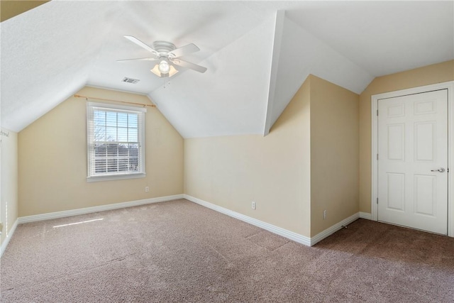 bonus room with visible vents, lofted ceiling, carpet floors, baseboards, and ceiling fan