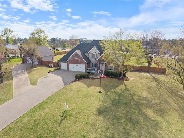 5102 Grove Dr, Rogers, AR 72758 - traditional-style home featuring a garage, brick siding, fence, a front lawn, and concrete driveway