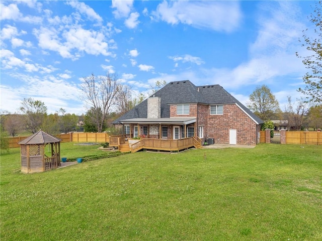 5102 Grove Dr, Rogers, AR 72758 - rear view of property with brick siding, a fenced backyard, and a yard