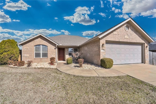 single story home with brick siding, a shingled roof, a front lawn, concrete driveway, and a garage