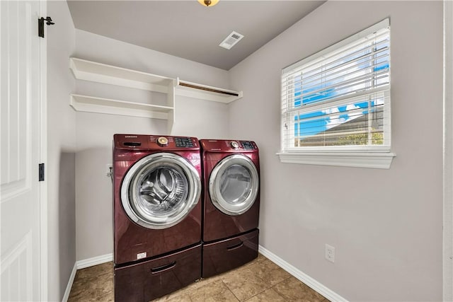 laundry area with visible vents, independent washer and dryer, tile patterned flooring, baseboards, and laundry area