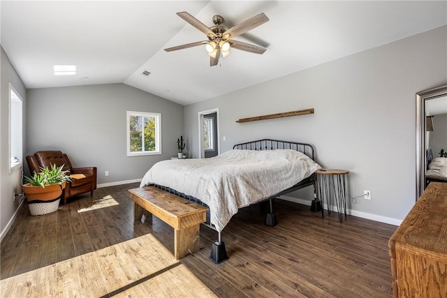 bedroom featuring visible vents, baseboards, lofted ceiling, and wood finished floors