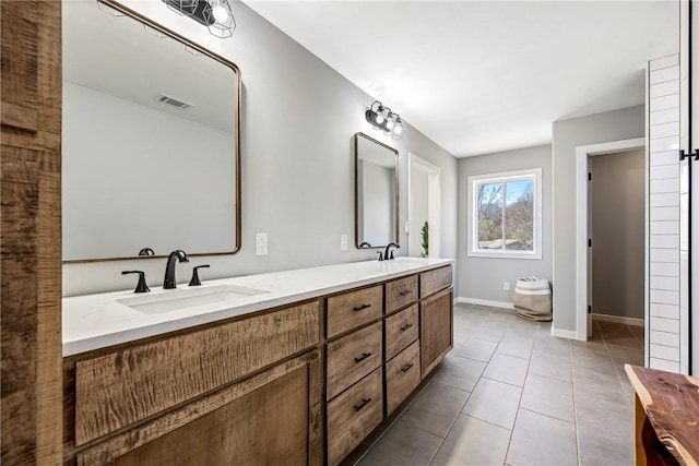 full bath with tile patterned flooring, double vanity, visible vents, and a sink