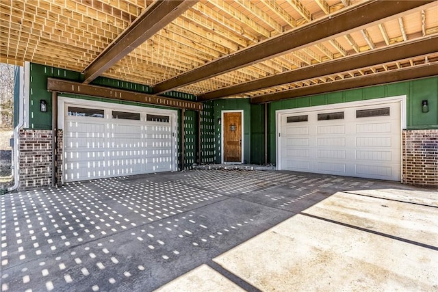 garage featuring concrete driveway