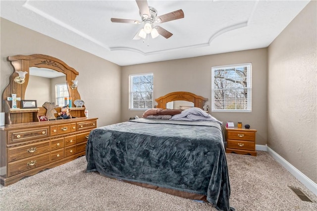 bedroom with carpet flooring, multiple windows, visible vents, and baseboards