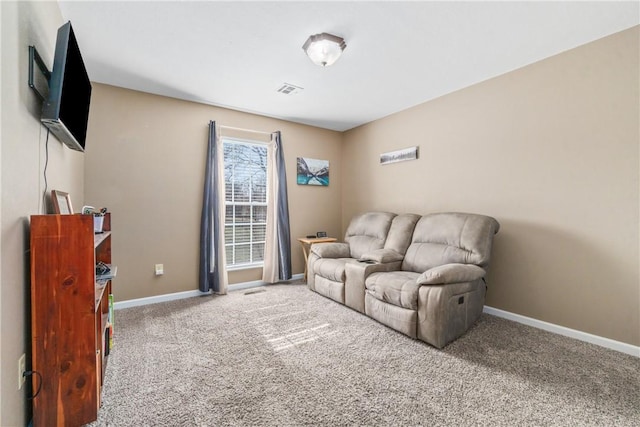 living area featuring carpet flooring, visible vents, and baseboards