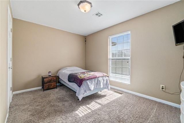 bedroom featuring visible vents, carpet floors, and baseboards