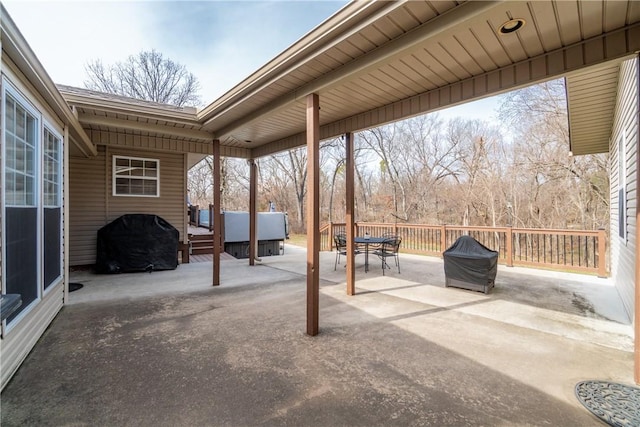 view of patio featuring a grill, outdoor dining area, and a deck