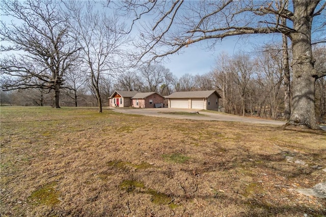 view of yard featuring a garage and driveway