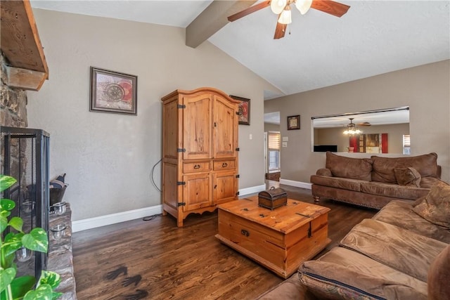 living area with dark wood-type flooring, a ceiling fan, a stone fireplace, baseboards, and vaulted ceiling with beams