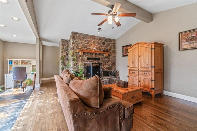 living area featuring a fireplace, vaulted ceiling with beams, baseboards, and wood finished floors