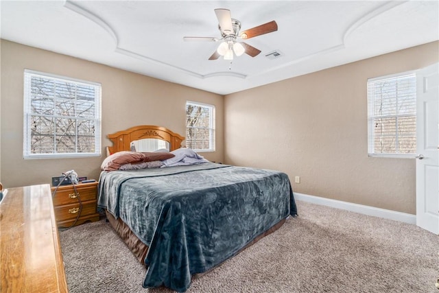 carpeted bedroom with baseboards, visible vents, and ceiling fan