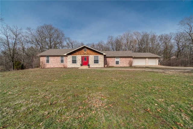 ranch-style home with a front lawn, an attached garage, and driveway