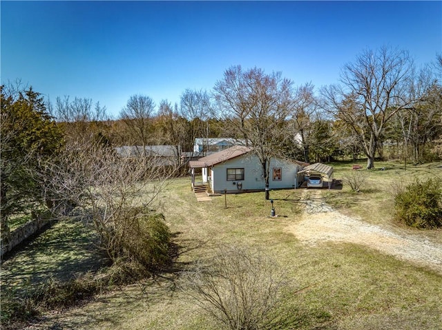 exterior space with fence and dirt driveway