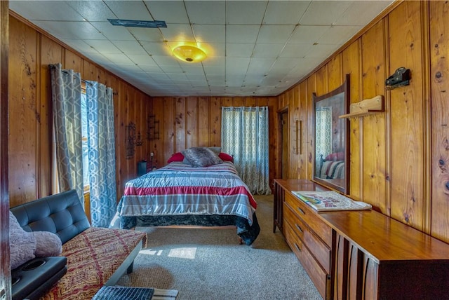 bedroom featuring carpet flooring and wood walls