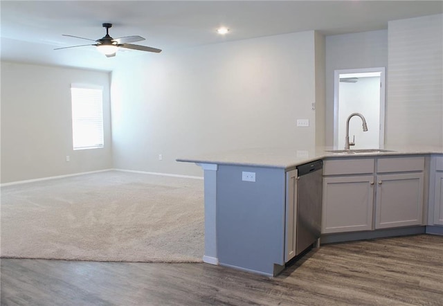 kitchen with open floor plan, dishwasher, light countertops, and a sink