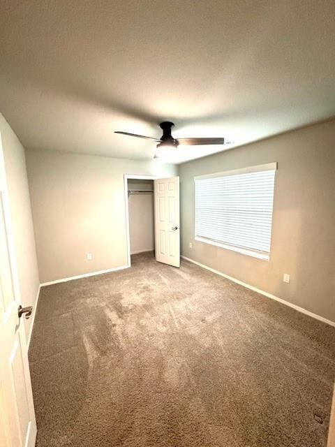 unfurnished bedroom with a closet, baseboards, and carpet floors