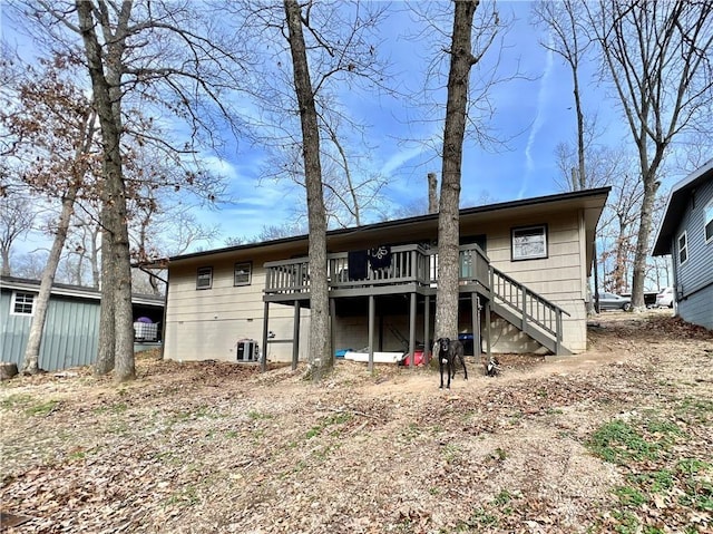 back of house with a deck and stairs